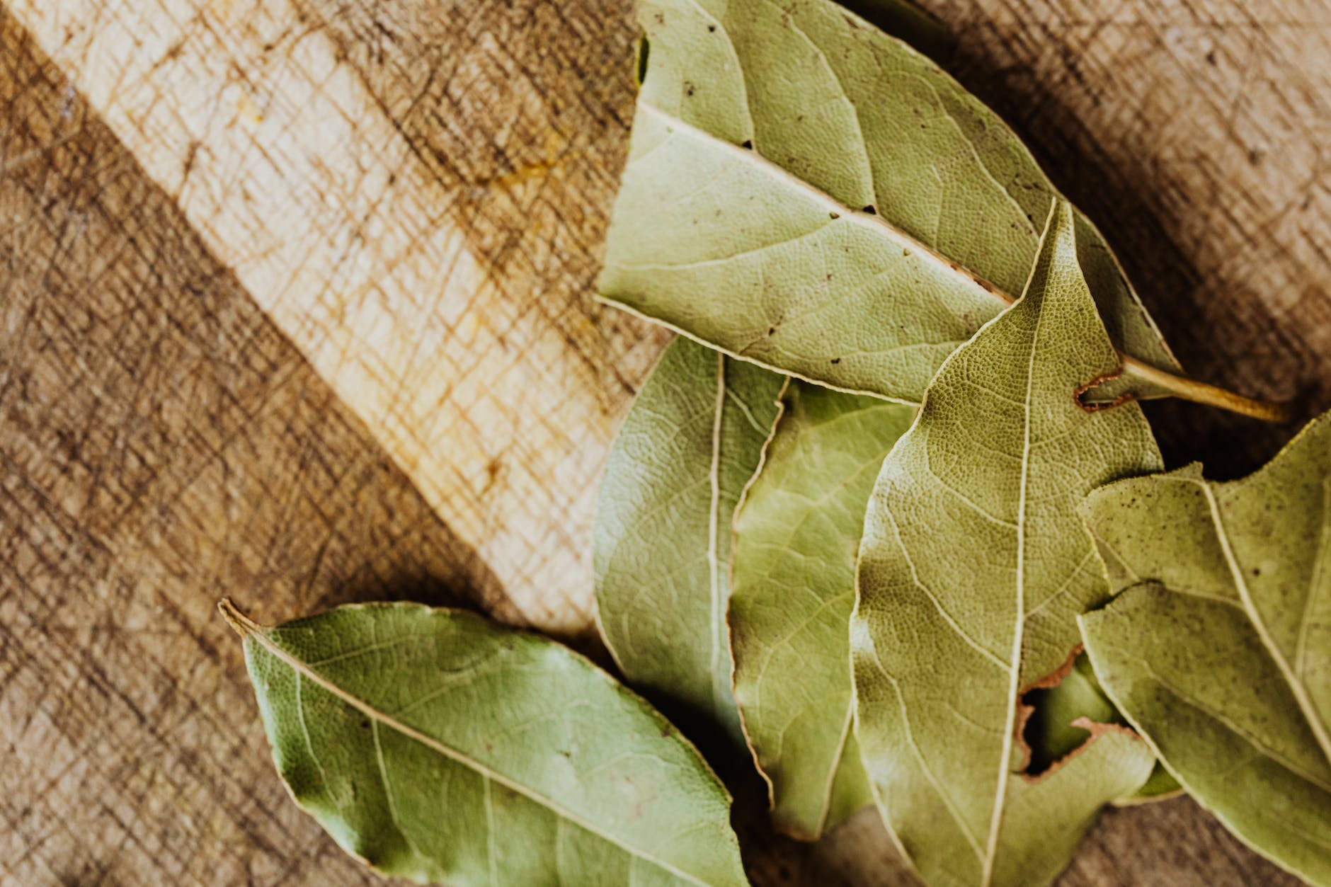 close up of dried bay leaves on cutting board