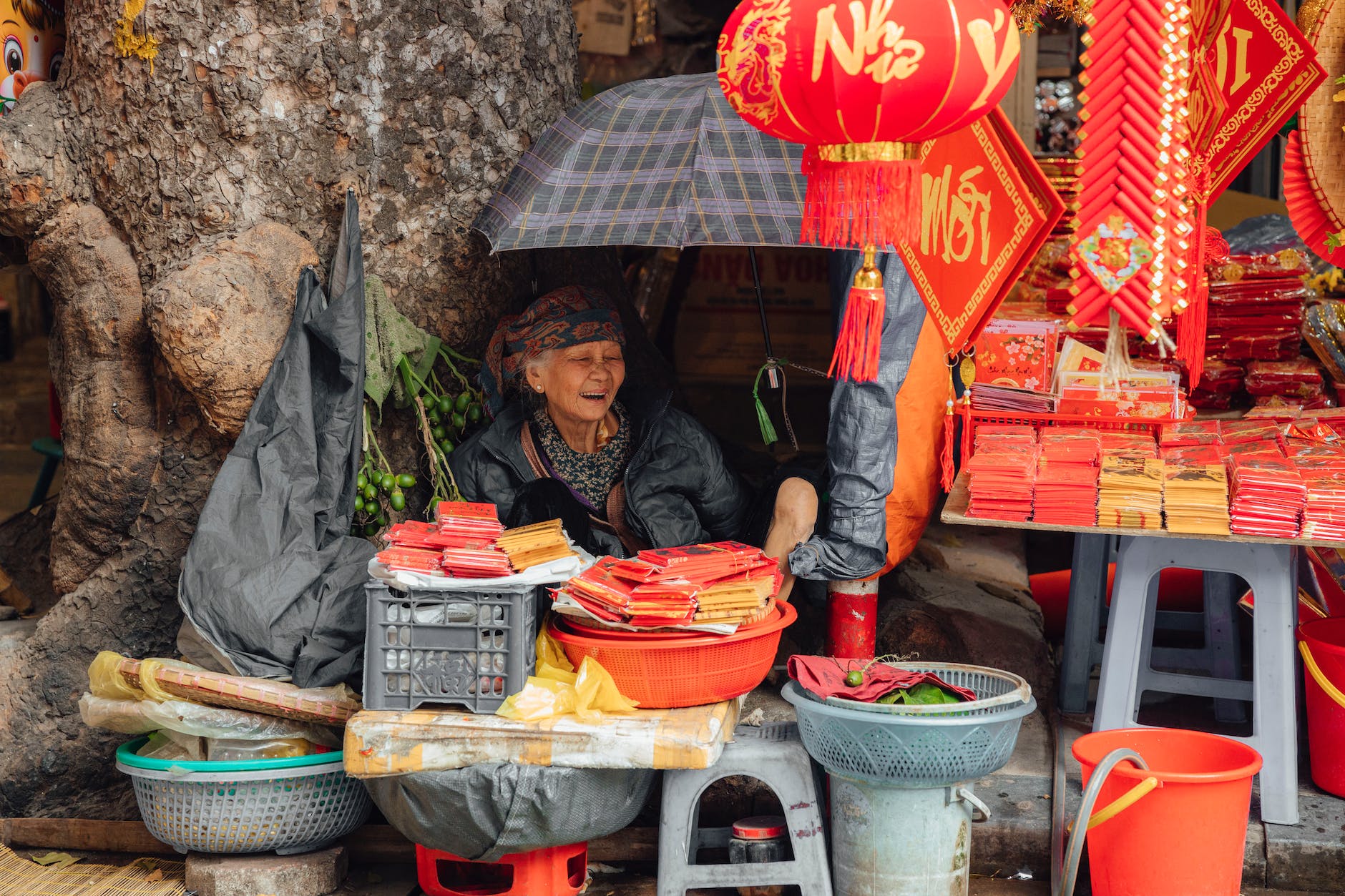 a happy woman selling chinese new year decorations